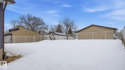 Yard layered in snow featuring a fenced backyard - 