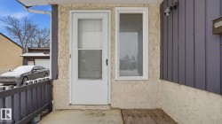 View of exterior entry with stucco siding - 