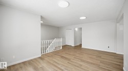 Family room with a textured ceiling and light wood-type flooring - 