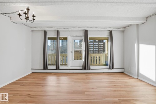 Spare room with light wood finished floors and a textured ceiling - 1103 9918 101 Street, Edmonton, AB - Indoor Photo Showing Other Room