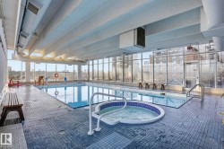 Indoor community pool with a hot tub and a patio area - 