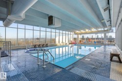 Indoor community pool featuring a sunroom and a patio - 