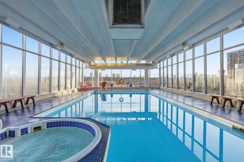 Integrated pool / hot tub featuring a sunroom - 1103 9918 101 Street, Edmonton, AB - Indoor Photo Showing Other Room With In Ground Pool