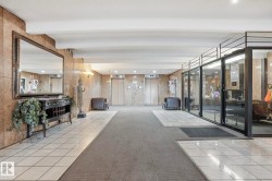 Building lobby with recessed lighting and beamed ceiling - 