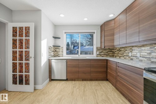 Kitchen with dishwasher, light stone counters, tasteful backsplash, recessed lighting, and a textured ceiling - 13911 117 Avenue, Edmonton, AB - Indoor Photo Showing Kitchen With Upgraded Kitchen