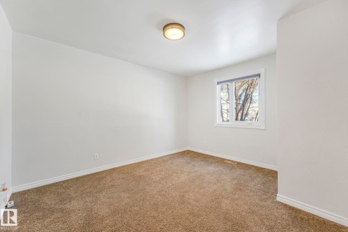 Empty room featuring baseboards and carpet flooring - 13911 117 Avenue, Edmonton, AB - Indoor Photo Showing Other Room