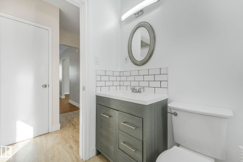 Half bath with vanity, backsplash, and light tile patterned flooring - 13911 117 Avenue, Edmonton, AB - Indoor