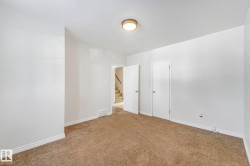 Unfurnished bedroom with baseboards and carpet flooring - 