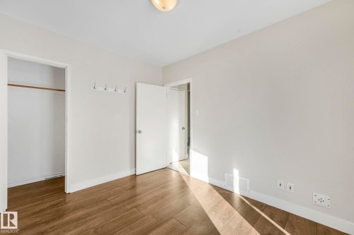 Unfurnished bedroom featuring dark wood finished floors and a closet - 13911 117 Avenue, Edmonton, AB - Indoor Photo Showing Other Room