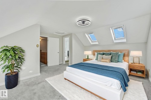 Carpeted bedroom with vaulted ceiling, ensuite bathroom, and a skylight - 13911 117 Avenue, Edmonton, AB - Indoor Photo Showing Bedroom