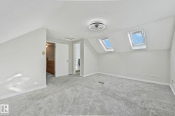 Bonus room featuring vaulted ceiling, carpet, and a skylight - 