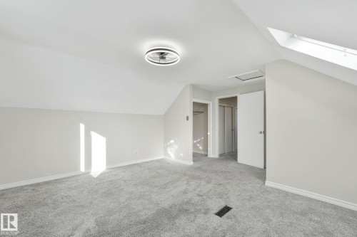 Additional living space featuring lofted ceiling, carpet, and a skylight - 13911 117 Avenue, Edmonton, AB - Indoor Photo Showing Other Room