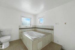 Full bath with a bath and light tile patterned floors - 