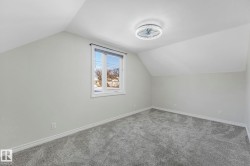 Additional living space featuring carpet floors and baseboards - 