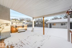 Yard covered in snow with a fenced backyard - 
