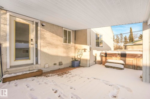 Snow covered patio with a hot tub - 13911 117 Avenue, Edmonton, AB - Outdoor With Exterior
