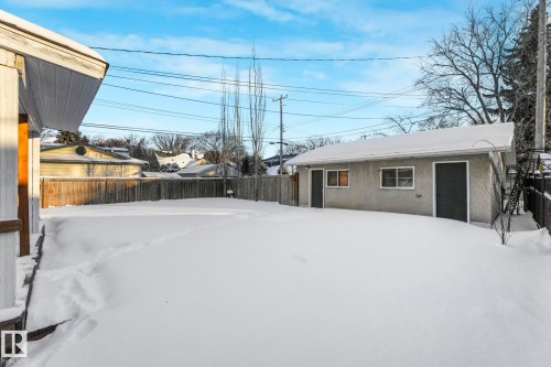 Yard covered in snow featuring a fenced backyard - 13911 117 Avenue, Edmonton, AB - Outdoor