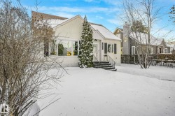Bungalow with stucco siding and a chimney - 