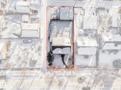 Aerial view of residential area featuring property boundaries highlighted - 