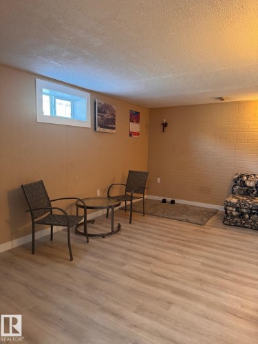 Recessed window with white trim, light wood-finish flooring, and a portion of a textured accent wall - 2910 132A Avenue, Edmonton, AB - Indoor
