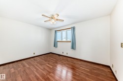 Unfurnished room featuring wood finished floors and ceiling fan - 