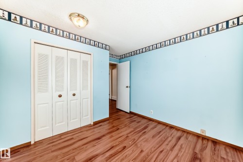 Unfurnished bedroom with a closet and wood finished floors - 11922 138 Avenue, Edmonton, AB - Indoor Photo Showing Other Room