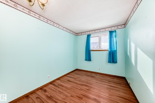 Empty room featuring wood finished floors and baseboards - 11922 138 Avenue, Edmonton, AB - Indoor Photo Showing Other Room