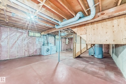 Below grade area with separate washer and dryer and water heater - 11922 138 Avenue, Edmonton, AB - Indoor Photo Showing Basement