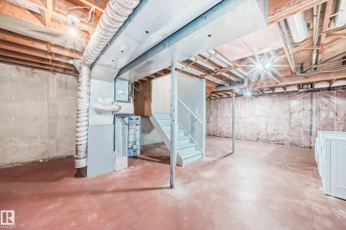 Unfinished basement featuring gas water heater, washer / dryer, and heating unit - 11922 138 Avenue, Edmonton, AB - Indoor Photo Showing Basement