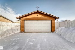 Snow covered garage with a garage - 