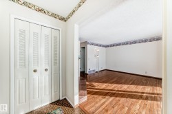 Foyer with hardwood / wood-style flooring and a textured ceiling - 