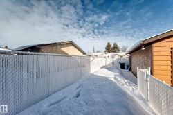 View of snowy exterior featuring a fenced backyard - 