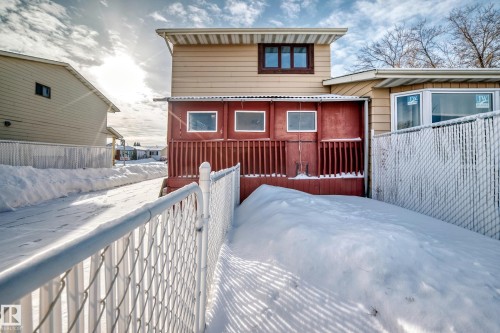 Snow covered house featuring a wooden deck - 11922 138 Avenue, Edmonton, AB - Outdoor With Exterior