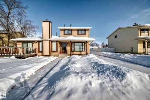 Snow covered rear of property featuring a chimney - 11922 138 Avenue, Edmonton, AB - Outdoor With Facade
