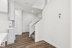 Staircase featuring wood finished floors and recessed lighting - 