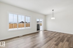 Unfurnished room featuring wood finished floors and baseboards - 