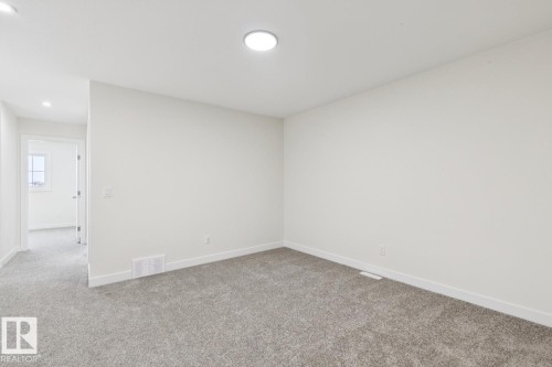 Spare room featuring light colored carpet and recessed lighting - 407 26 Street, Edmonton, AB - Indoor Photo Showing Other Room
