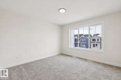 Carpeted empty room with baseboards - 