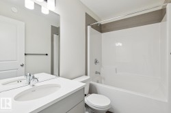 Bathroom with vanity and washtub / shower combination - 