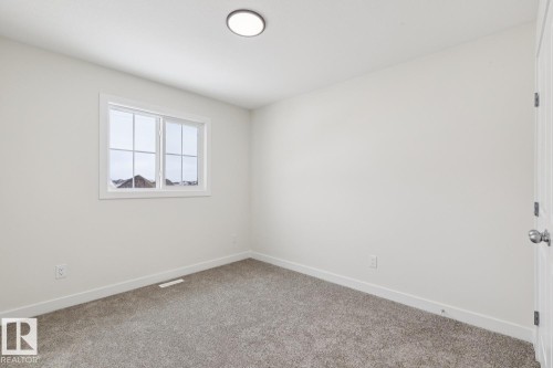 Carpeted spare room featuring baseboards - 407 26 Street, Edmonton, AB - Indoor Photo Showing Other Room