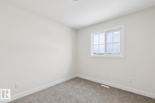 Carpeted spare room featuring baseboards - 407 26 Street, Edmonton, AB - Indoor Photo Showing Other Room