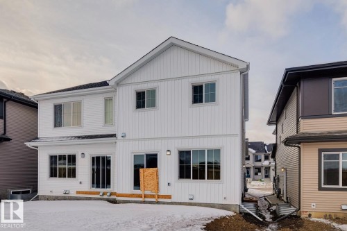 Snow covered rear of property featuring board and batten siding - 407 26 Street, Edmonton, AB - Outdoor