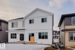 Snow covered rear of property featuring board and batten siding - 