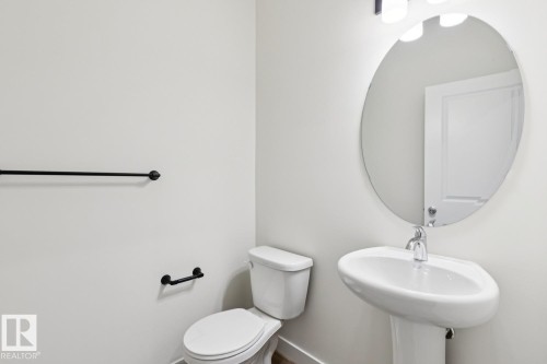 Bathroom with toilet and baseboards - 407 26 Street, Edmonton, AB - Indoor Photo Showing Bathroom
