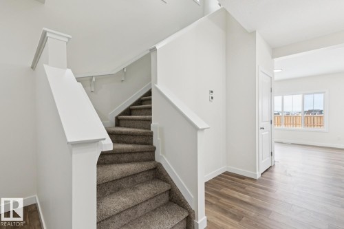 Stairway with wood finished floors and baseboards - 407 26 Street, Edmonton, AB - Indoor Photo Showing Other Room