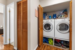 Laundry area with wood finished floors and separate washer and dryer - 