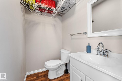 Half bathroom with vanity and dark wood-style floors - 36 2204 118 Street, Edmonton, AB - Indoor Photo Showing Bathroom