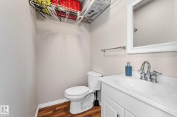 Half bathroom with vanity and dark wood-style floors - 