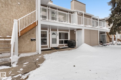 Snow covered house featuring a patio area and a chimney - 36 2204 118 Street, Edmonton, AB - Outdoor