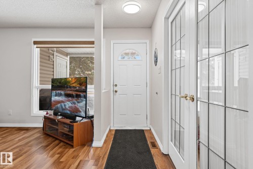 Foyer entrance with a textured ceiling and light wood-type flooring - 36 2204 118 Street, Edmonton, AB - Indoor Photo Showing Other Room